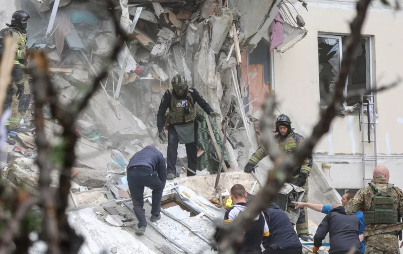 Volunteers and firefighters operate on the site of an apartment building which partially collapsed after being damaged by a Ukrainian strike in Belgorod on May 12, 2024. At least 20 people were injured, in the partial collapse of a building in Belgorod, after a Ukrainian strike, emergency services announced on May 12, 2024, after the Russian defence ministry said a Ukrainian Tochka-U missile hit a "residential district" in the city after it was intercepted by air defences. (Photo by STRINGER / AFP)