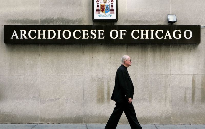 CHICAGO - SEPTEMBER 27: A priest walks past the offices of the Catholic Archdiocese of Chicago September 27, 2005 in Chicago, Illinois. The Archdiocese of Chicago has removed 11 priests from their positions in various Chicago and suburban locations after sexual misconduct allegations involving them were brought to light. (Photo by Tim Boyle/Getty Images)