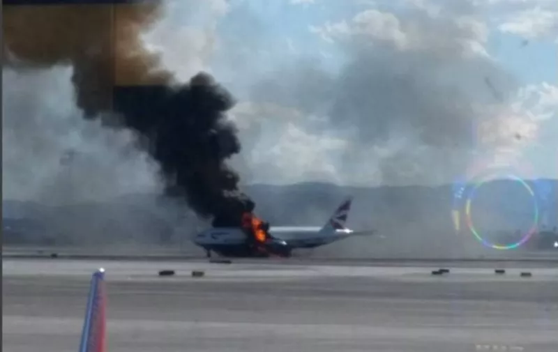 This photograph posted on Instagram and taken September 8, 2015 shows a passenger plane on fire on the runway at McCarran International Airport in Las Vegas, Nevada.  A British Airways jet caught fire on the runway at McCarran International Airport in Las Vegas Tuesday, forcing the evacuation of the passengers on board. The Federal Aviation Administration said the fire broke out in the plane's left engine prompting the crew to abort takeoff.  AFP PHOTO/HANDOUT/ Reggie Bügmüncher == RESTRICTED TO EDITORIAL USE / MANDATORY CREDIT: "AFP PHOTO / HANDOUT / REGGIE BÜGMÜNCHER"/ NO MARKETING / NO ADVERTISING CAMPAIGNS / DISTRIBUTED AS A SERVICE TO CLIENTS ==
