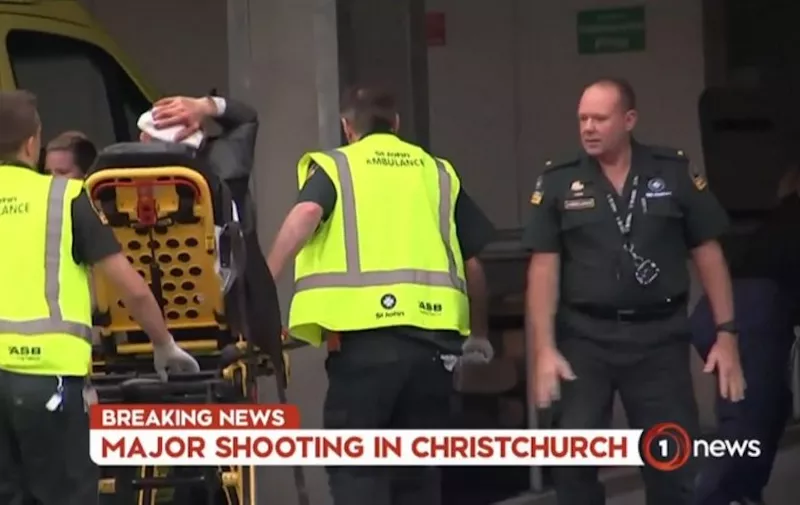 An image grab from TV New Zealand taken on March 15, 2019 shows a victim holding his head as he arrives at a hospital following the mosque shooting in Christchurch. - At least one gunman who targeted crowded mosques in the New Zealand city of Christchurch killed a number of people, police said, with Prime Minister Jacinda Ardern describing the shooting as "one of New Zealand's darkest days". (Photo by Laurent FIEVET / TV New Zealand / AFP) / New Zealand OUT / XGTY----EDITORS NOTE ----RESTRICTED TO EDITORIAL USE MANDATORY CREDIT " AFP PHOTO / TV New Zealand / NO MARKETING NO ADVERTISING CAMPAIGNS - DISTRIBUTED AS A SERVICE TO CLIENTS- NO ARCHIVE