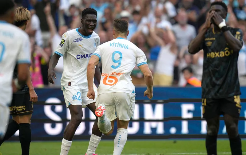 Marseille's Vitor Oliveira Vitinha, centre, celebrates after scoring his side's second goal during the French League One soccer match between Marseille and Reims at the Velodrome stadium in Marseille, France, Saturday, Aug. 12, 2023. (AP Photo/Daniel Cole)