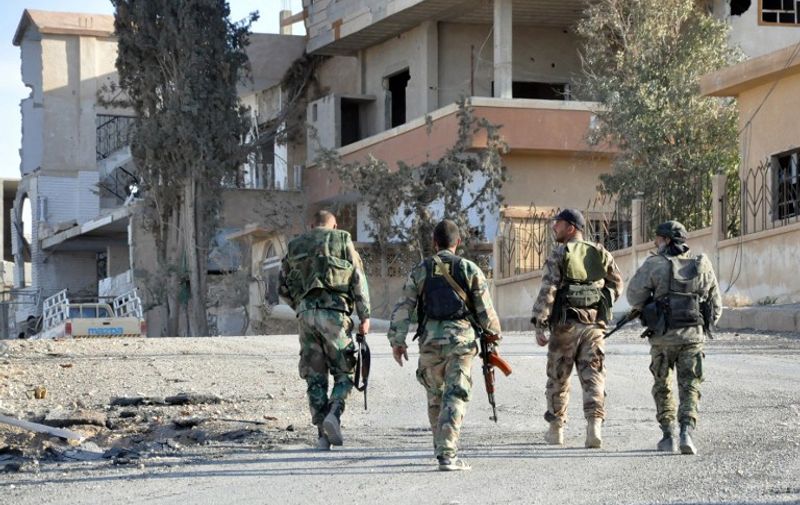 Syrian soldiers patrol the town of al-Quaryatayn in Syria's central Homs province, on April 3, 2016.
Syrian troops seized the key Islamic State (IS) group bastion of Al-Quaryatayn, dealing the jihadists a new blow in the country's centre a week after expelling them from Palmyra, state television said.

 / AFP PHOTO / STRINGER