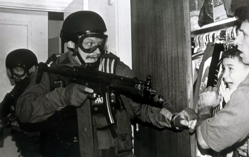 This photograph released 16 April 2001 by Columbia University in New York and taken by Alan Diaz of the Associated Press, which won the Pulitzer Prize for Breaking News Photography. The photo shows Cuban refugee Elian Gonzalez and Donato Dalrymple (R) in a bedroom closet as federal agents enter the Miami home of Elian's relatives and was taken 22 April 2000.  AFP PHOTO/Alan Diaz/Associated Press