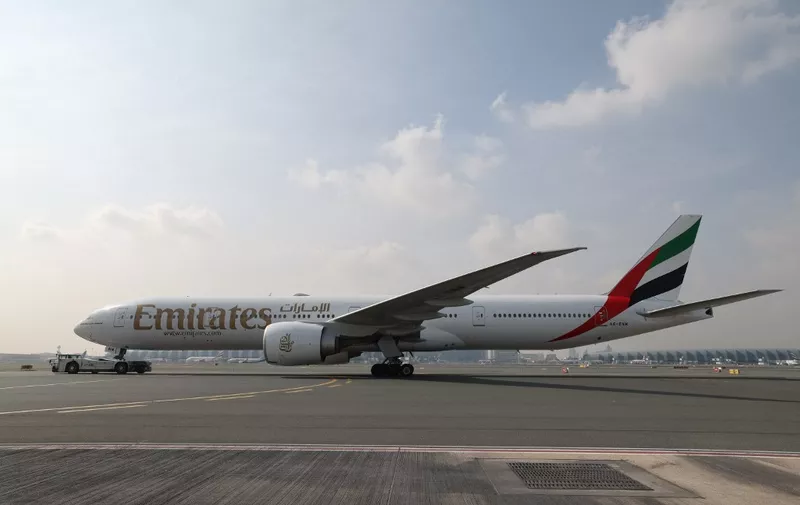 An Emirates Boeing 777-300ER aircraft is pictured at the tarmac at Dubai International Airport, on November 22, 2023. (Photo by Giuseppe CACACE / AFP)
