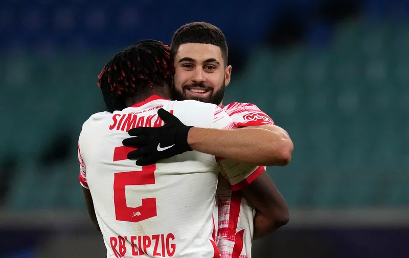 Leipzig's Mohamed Simakan, front, celebrates with Leipzig's Josko Gvardiol at the end of the Group A Champion's League soccer match between RB Leipzig and Manchester City at the Red Bull Arena in Leipzig, Germany, Tuesday, Dec. 7, 2021. (AP Photo/Michael Sohn)