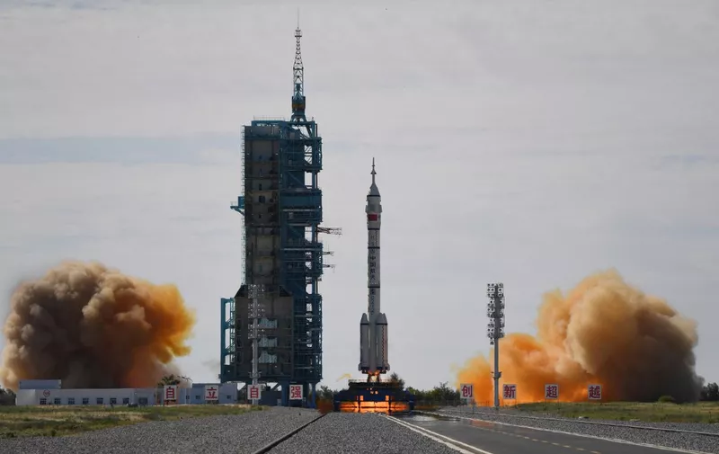 A Long March-2F carrier rocket, carrying the Shenzhou-12 spacecraft and a crew of three astronauts, lifts off from the Jiuquan Satellite Launch Centre in the Gobi desert in northwest China on June 17, 2021, the first crewed mission to China's new space station. (Photo by GREG BAKER / AFP)