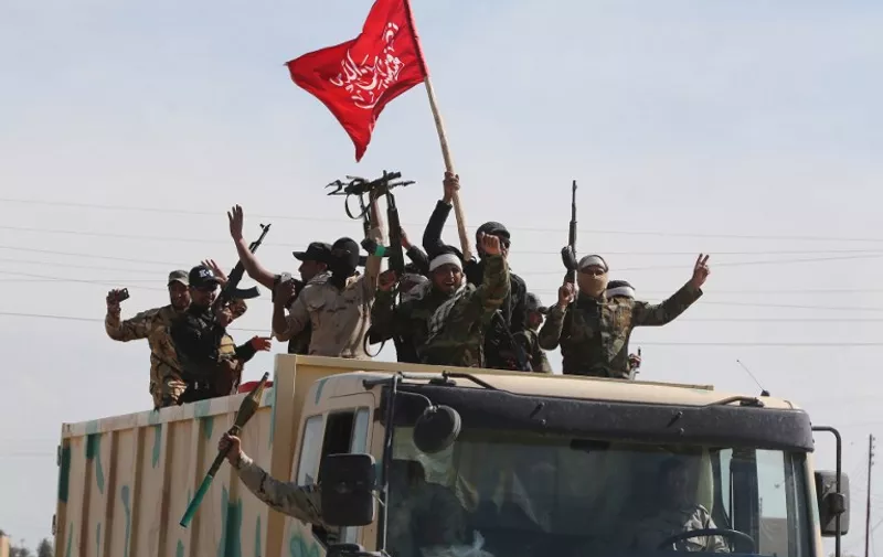 Iraqi Shiite fighters from the Popular Mobilisation units head towards the Iraqi city of Tikrit, on March 17, 2015 after recapturing the town of Al-Alam from Islamic State (IS) fighters earlier in the month. Loyalists had already failed three times to retake the nearby city of Tikrit, the hometown of Saddam Hussein, which was captured by IS last summer. AFP PHOTO / AHMAD AL-RUBAYE / AFP PHOTO / AHMAD AL-RUBAYE