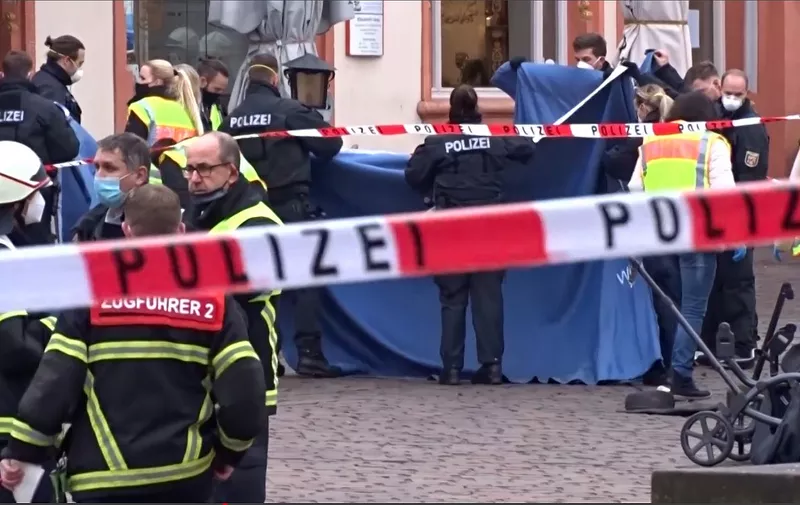 This image grab taken from a video obtained from Steil-TV shows police covering victims in blankets at the scene where a car drove into pedestrians in the center of Trier, southwestern Germany, on December 1, 2020. - At least two people were killed and several injured when a car drove into a pedestrian zone in the southwestern German city of Trier on December 1, 2020, police said, adding that the driver had been arrested. (Photo by STEIL-TV / various sources / AFP)