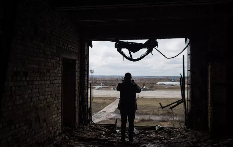 HOSTOMEL, UKRAINE - MARCH 19: A man takes a photo of destruction as traces of war are seen in Antonov Airport in Hostomel, Ukraine on March 19, 2024. Hostomel Airport played a pivotal role at the onset of the Russia-Ukraine war, serving as a critical site where the Ukrainian military thwarted the Russian army's attempt to attack Kyiv. The airport also served as a primary hub for Russian aircraft, which the Ukrainian forces neutralized. Adri Salido / Anadolu (Photo by Adri Salido / ANADOLU / Anadolu via AFP)