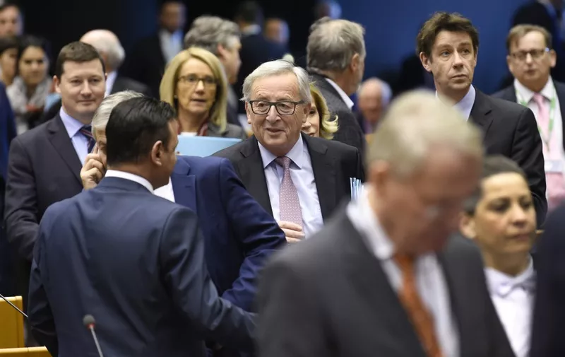 EU Commission President Jean-Claude Juncker (C) arrives prior to the start of the presentation of the ''White paper on the future of Europe'' at the EU headquarters in Brussels on March 1, 2017. - Juncker revealed his plans to save the EU, warning the troubled bloc must now write a "new chapter" after Britain's expected exit in 2019. The former Luxembourg premier laid out five "pathways to unity" for European Union leaders to consider at a special summit in Rome on March 25 to mark the 60th anniversary of the bloc's founding treaty. (Photo by JOHN THYS / AFP)
