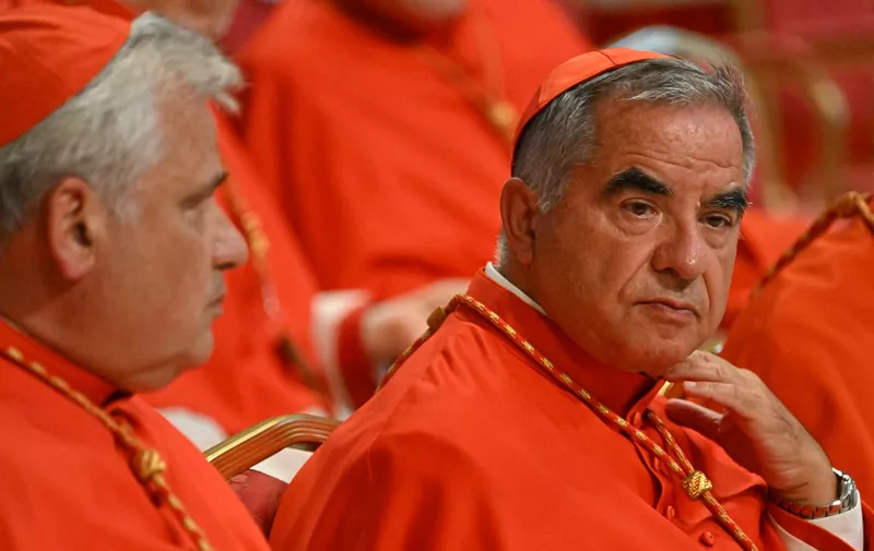 (FILES) Italian Cardinal Giovanni Angelo Becciu (R) waits prior to the start of a consistory during which 20 new Cardinals are to be created by the Pope, on August 27, 2022 at St. Peter's Basilica in The Vatican. A Vatican court on December 16, 2023 convicted a once powerful Italian cardinal to five years and six months in jail for financial crimes at the end of a historic trial. Angelo Becciu, 75, a former advisor to Pope Francis who was once considered a papal contender himself, had strongly denied charges that included embezzlement and abuse of office. (Photo by Alberto PIZZOLI / AFP)