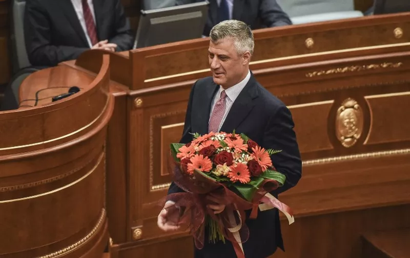 Newly elected President of Kosovo Hashim Thaci holds flowers during an extraordinary session in Pristina on February 26, 2016.
Kosovo MPs elected foreign minister and former premier Hashim Thaci as president on February 26 after a tense day of voting marred by protests inside parliament and on the streets.
 / AFP / ARMEND NIMANI