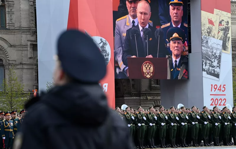A screen shows Russian President Vladimir Putin giving a speech as servicemen line up on Red Square during the Victory Day military parade in central Moscow on May 9, 2022. - Russia celebrates the 77th anniversary of the victory over Nazi Germany during World War II. (Photo by Kirill KUDRYAVTSEV / AFP)