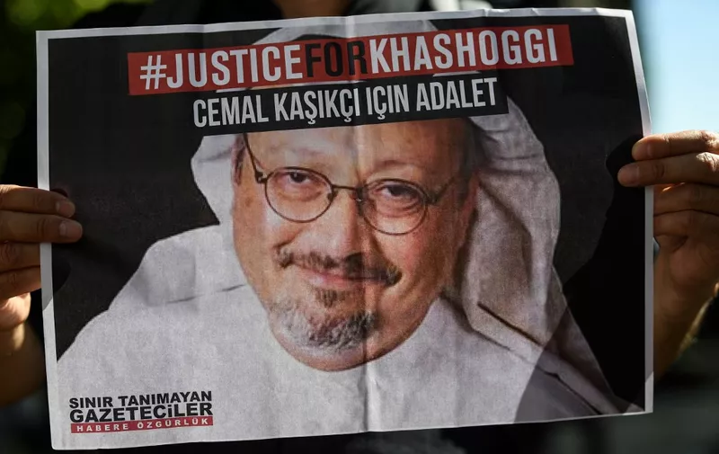Friends of murdered Saudi journalist Jamal Khashoggi hold posters bearing his picture as they attend an event marking the second-year anniversary of his assassination in front of Saudi Arabia Istanbul Consulate, on October 2, 2020. - Khashoggi, a Washington Post columnist, was killed and dismembered at the Saudi consulate in Istanbul on October 2, 2018, in an operation that reportedly involved 15 agents sent from Riyadh. His remains have not been found. (Photo by Ozan KOSE / AFP)