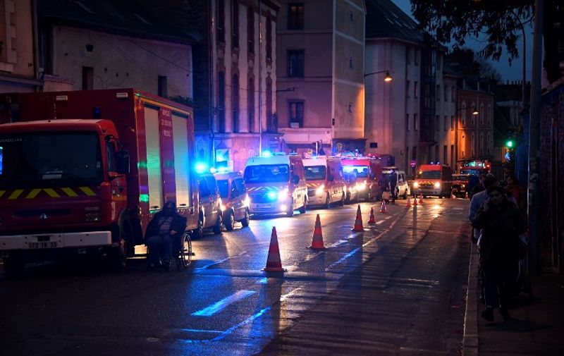 Firefighters' and Rescue vehicles gather in downtown Rennes, northwestern France, after the floor of the Noz store collapsed on November 19, 2016.  
The floor of a store collapsed on NOvember 19 in the afternoon in downtown Rennes, lightly injuring three people, an accident possibly due to the underground construction site of the metro line, the fire brigade and the prefecture of Ille-et-Vilaine said. / AFP PHOTO / Damien MEYER