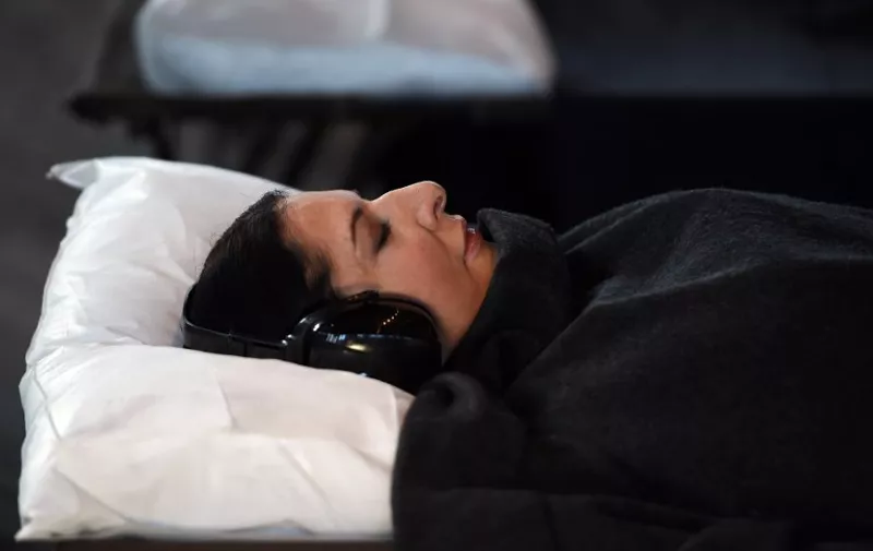Performance artist Marina Abramovic lies in a bed during a media preview of her 12-day project titled "Marina Abramovic: In Residence" in Sydney on June 23, 2015. The project that involves public as part of the art is presented free-­of-­charge to the public and runs from June 24 - July 5.  AFP PHOTO / Saeed KHAN
RESTRICTED TO EDITORIAL USE, MANDATORY MENTION OF THE ARTIST UPON PUBLICATION, TO ILLUSTRATE THE EVENT AS SPECIFIED IN THE CAPTION