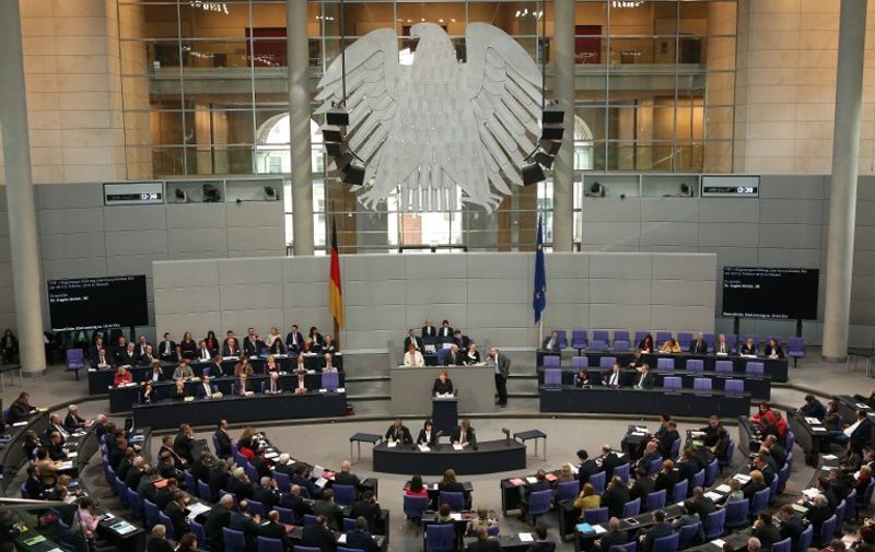 German Chancellor Angela Merkel addresses Bundestag members before the European Council meeting in Brussels in Berlin on February 17, 2016. / AFP / Adam BERRY