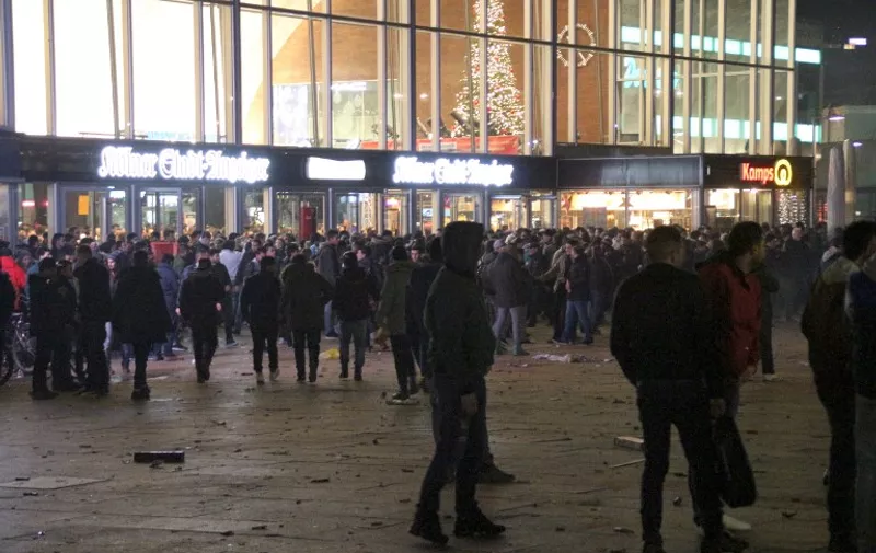 Picture taken on December 31, 2015 shows people gathering in front of the main railway station in Cologne, western Germany.
Police in Cologne told AFP they have received more than 100 complaints by women reporting assaults ranging from groping to at least one reported rape, allegedly committed in a large crowd of revellers during year-end festivities outside the city's main train station and its famed Gothic cathedral. / AFP / dpa / Markus Boehm / Germany OUT