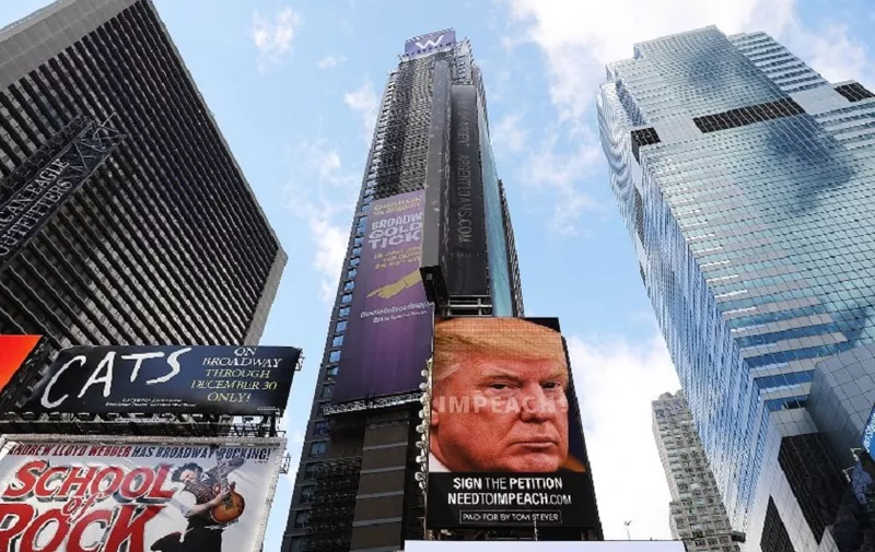 NEW YORK, NY - NOVEMBER 20: A billboard in Times Square, funded by Philanthropist Tom Steyer, calls for the impeachment of President Donald Trump on November 20, 2017 in New York City. Steyer, an American hedge fund manager, environmentalist, progressive activist, and fundraiser has pledged $20 million for an ad campaign urging for the impeachment of President Donald Trump. The billboards will go up in various locations across the United States.   Spencer Platt/Getty Images/AFP