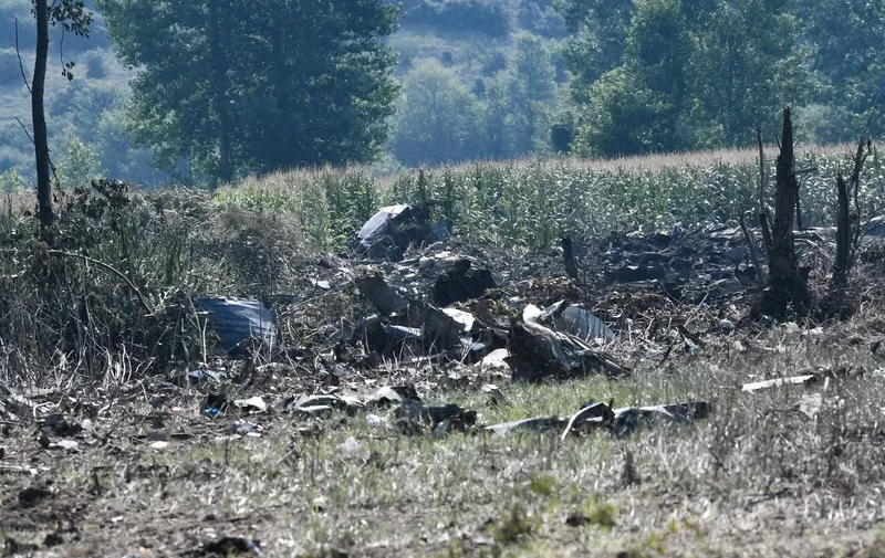 This picture taken on July 17, 2022, shows debris on the crash site of an Antonov An-12 cargo aircraft a few kilometres away from the city of Kavala in Greece. - A cargo aircraft Antonov An-12 crashed near Paleochori Kavalas in northern Greece, the fire brigade said. Eye-witnesses said the aircraft was on fire and that they had heard explosions, Athens News Agency reported. (Photo by Sakis MITROLIDIS / AFP)