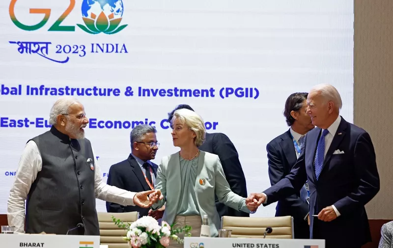 European Commission President Ursula von der Leyen (C) holds hands with US President Joe Biden (R) and India's Prime Minister Narendra Modi during a session on 'Partnership for Global Infrastructure and Investment' as part of the G20 summit in New Delhi on September 9, 2023. (Photo by EVELYN HOCKSTEIN / POOL / AFP)