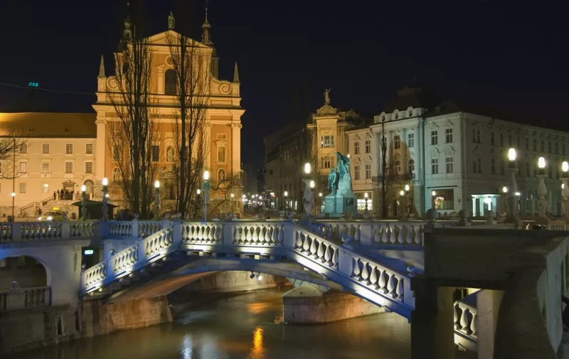 Tromstovje Triple bridge over the River Ljubljanica, Franciscan Church and Preseeren Square at night, Ljubljana, Slovenia, Eastern Europe, Europe (Photo by Christian Kober / Robert Harding Premium / robertharding via AFP)