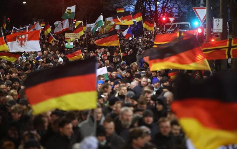 DRESDEN, GERMANY - JANUARY 12:  Supporters of the Pegida movement wave German and other flags while strolling through the city center during their weekly protest on January 12, 2015 in Dresden, Germany. Pegida is an acronym for 'Patriotische Europaeer Gegen die Islamisierung des Abendlandes,' which translates to 'Patriotic Europeans Against the Islamification of the West,' and has quickly gained local mass appeal by demanding a more restrictive policy on Germany's acceptance of foreign refugees and asylum seekers. Critics, including leading German politicians, implored Pegida supporters not to march tonight and not to use the Paris attacks as a means to further their goals, which many view as xenophobic. The first Pegida march took place in Dresden in October and Pegida has since attracted thousands of participants to its weekly gatherings that have also begun spreading to other cities in Germany, though so far with only a few hundred participants. Germany is accepting a record number of refugees this year, especially from war-torn Syria, and the country has also witnessed the rise of Salafist movements in numerous immigrant-heavy German cities. Both phenomena have promoted Pegida's rise and appeal.  (Photo by Sean Gallup/Getty Images)