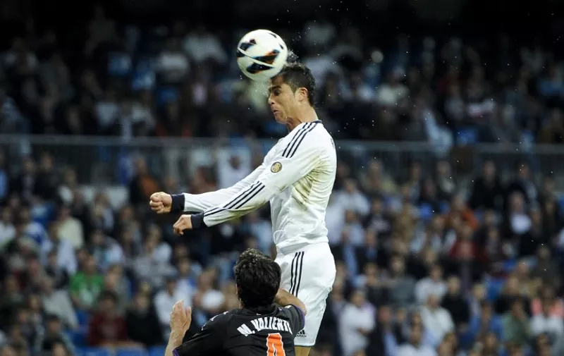 Real Madrid's Portuguese forward Cristiano Ronaldo heads the ball during the Spanish league football match Real Madrid CF vs Valladolid at the Santiago Bernabeu stadium in Madrid on May 4 , 2013.  AFP PHOTO / DANI POZO