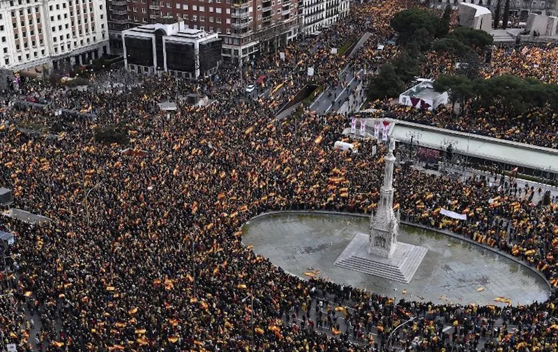 Right-wing protesters wave Spanish flags during a demonstration at Plaza de Colon in Madrid against Spanish Prime Minister Pedro Sanchez on February 10, 2019. - The conservative Popular Party (PP), centre-right Ciudadanos and far-right Vox have all called on their supporters to take to the streets of Madrid against Sanchez after accusing him of making concessions to Catalan separatists. (Photo by PIERRE-PHILIPPE MARCOU / AFP)