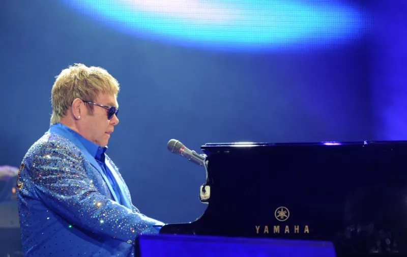 British musician Elton John performs during the third day of the Rock in Rio music festival at the City of Rock park in Rio de Janeiro, Brazil, on September 20, 2015.  AFP PHOTO / TASSO MARCELO