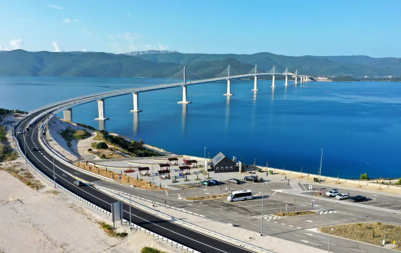 26.07.2023., Komarna - Pogled iz zraka na Peljeski most koji je otvoren 26. srpnja 2022. godine. Most je dugacak 2404 metara i naveca visina iznad mora iznosi 55 metara. Glavna je prometna poveznica kontinentalne Hrvatske s poluotokom Peljescem. Photo: Matko Begovic/PIXSELL