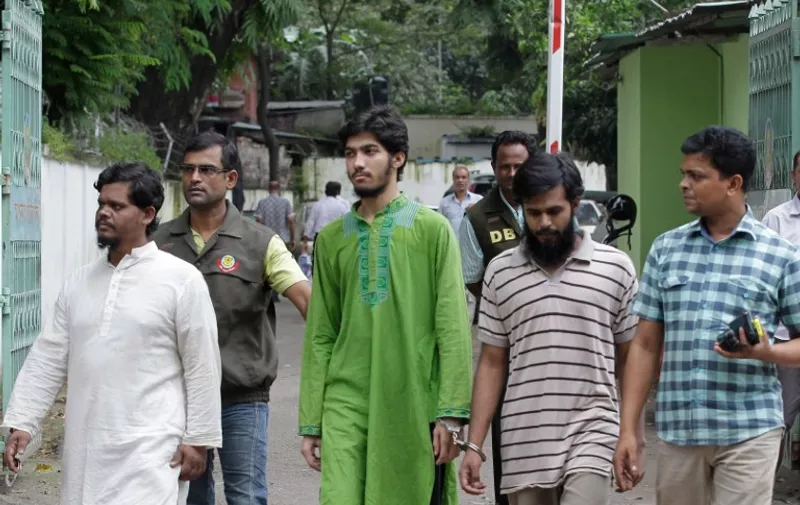 Bangladesh police escort the head of Islamic group the Ansarullah Bangla Team (ABT) Abul Bashar (L) and members Zafran Hassan (C) and Julhas Bishas (2R) after they were arrested over the murder of two bloggers in Dhaka on September 11, 2015. Bangladesh's elite security force on September 10 arrested the head of a banned hardline Islamist group over the murders of two atheist bloggers that has sparked an international outcry. AFP PHOTO / STR