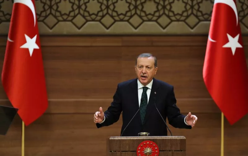 Turkish President Recep Tayyip Erdogan addresses a meeting at the presidential palace in Ankara on August 12, 2015. Erdogan vowed to fight on against Kurdistan Workers' Party (PKK) militants, in the face of mounting attacks on security forces blamed on the Kurdish rebels. AFP PHOTO/ADEM ALTAN
