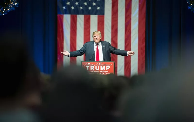 GRAND RAPIDS, MI - DECEMBER 21: Republican presidential candidate Donald Trump speaks to guests at a campaign rally on December 21, 2015 in Grand Rapids, Michigan. The full-house event was repeatedly interrupted by protestors. Trump continues to lead the most polls in the race for the Republican nomination for president.   Scott Olson/Getty Images/AFP