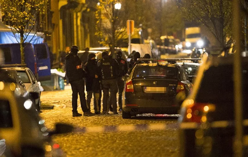 Policemen gather during an intervention in Brussels on November 22, 2015. Brussels will remain at the highest possible alert level with schools and metros closed over a "serious and imminent" security threat in the wake of the Paris attacks, the Belgian prime minister said. Belgian police have launched several operations linked to the "terrorist threat" facing Brussels, which is under a top security alert over fears of Paris-style attacks, a spokesman said. 
==BELGIUM OUT== / AFP / BELGA / LAURIE DIEFFEMBACQ
