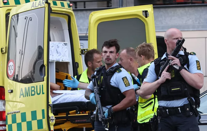An ambulance and armed police are seen during the evacuation of people at the Fields shopping center in Copenhagen, Denmark, on July 3, 2022 after Danish media reported a shooting. - Gunfire in a Copenhagen mall left several victims on Sunday, Danish police said.
Police reinforcements have been deployed around the large Field's mall between the city centre and the airport, Copenhagen police wrote on Twitter. "We're on the scene, shots were fired and several people have been hit," they said. (Photo by Olafur Steinar Gestsson / Ritzau Scanpix / AFP) / Denmark OUT