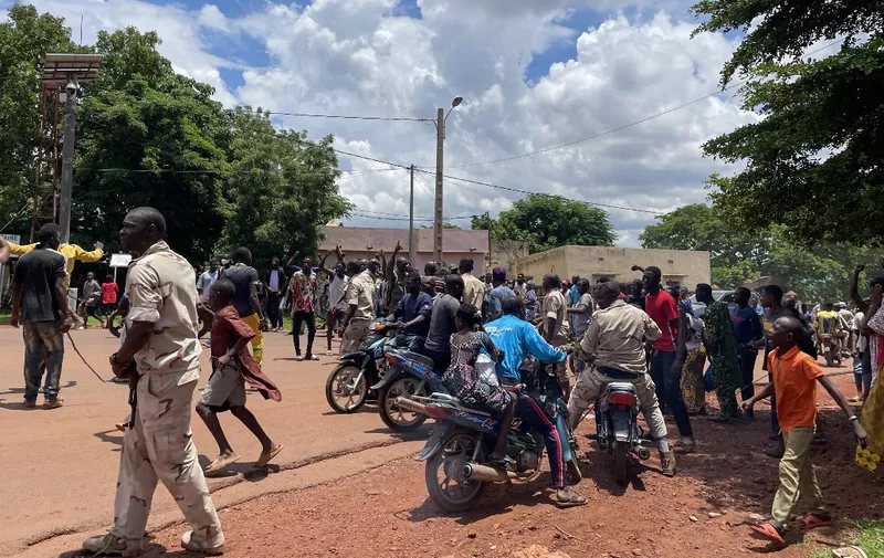 EDITORS NOTE: Graphic content / A crowd gathers around a man (not seen) suspected of taking part in thwarted "terrorist" attack after being beaten by a crowd, in front of the military base in Kati, Mali, on July 22, 2022. The Malian army said it had thwarted a "terrorist" attack on July 22, 2022 at a town on the outskirts of the capital where a key base used by the ruling military is located.
Armed forces "vigorously repelled" a dawn attack at the garrison town of Kati in which assailants used two explosives-laden vehicles, the army said on Facebook. (Photo by AFP)