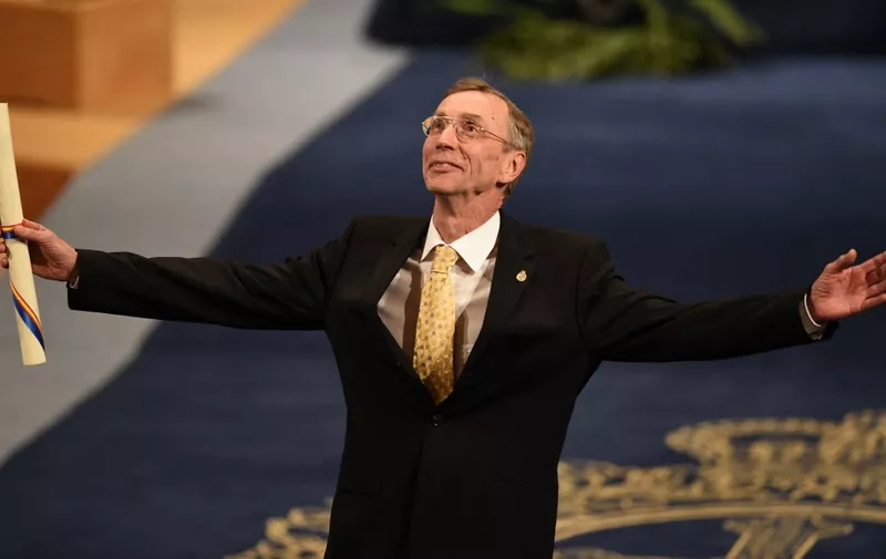 (FILES) In this file photo taken on October 19, 2018 Swedish biologist Svante Paabo celebrates on the stage after receiving the 2018 Princess of Asturias Award for Technical and Scientific Research during the Princess of Asturias Awards ceremony at the Campoamor Theatre in Oviedo, on October 19, 2018. - Swedish paleogeneticist Svante Paabo, who sequenced the genome of the Neanderthal and discovered the previously unknown hominin Denisova, on October 3, 2022 won the Nobel Medicine Prize. (Photo by MIGUEL RIOPA / AFP)