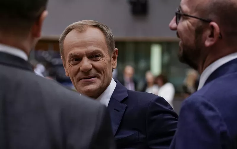 European Council President Donald Tusk (C) speaks with Belgium's Prime minister Charles Michel (R) as he arrives for a European Union Summit at European Union Headquarters in Brussels on October 18, 2019. (Photo by Kenzo TRIBOUILLARD / AFP)