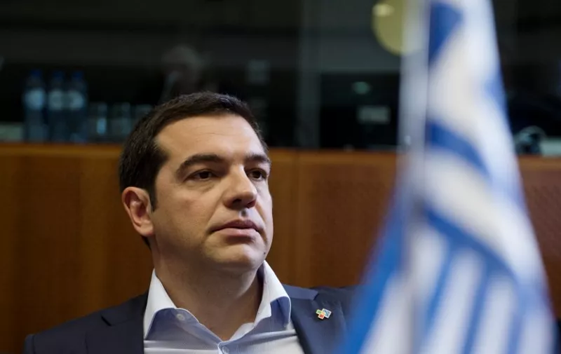 Greece's Prime minister Alexis Tsipras looks on prior to a round table as part of an extraordinary "EU-CELAC" council on June 10, 2015 at the European Union headquarters in Brussels.   AFP PHOTO / ALAIN JOCARD