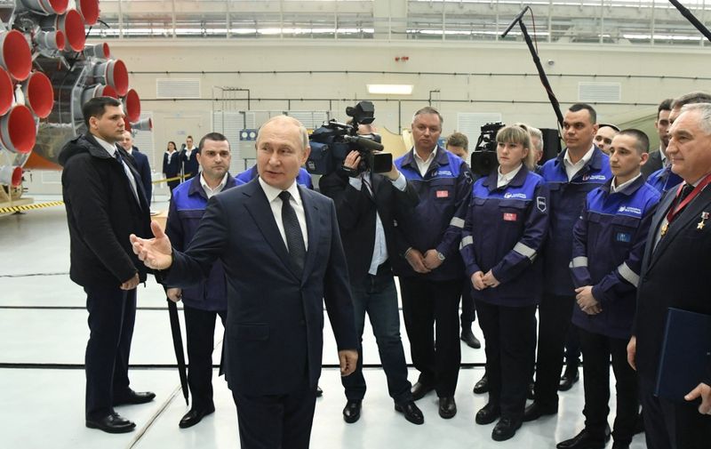 Russian President Vladimir Putin speaks with workers, as he visits the Vostochny cosmodrome, some 180 km north of Blagoveschensk, Amur region on April 12, 2022. (Photo by Yevgeny BIYATOV / Sputnik / AFP)