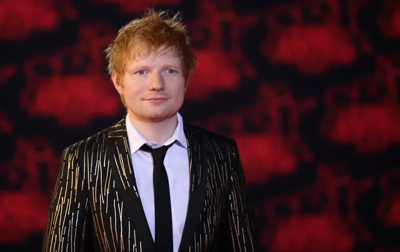 British singer Edward Christopher Sheeran aka 'Ed Sheeran' poses on the red carpet prior the 23st NRJ Music Awards ceremony at the Palais des Festivals in Cannes, south-eastern France, on November 20, 2021. (Photo by Valery HACHE / AFP)