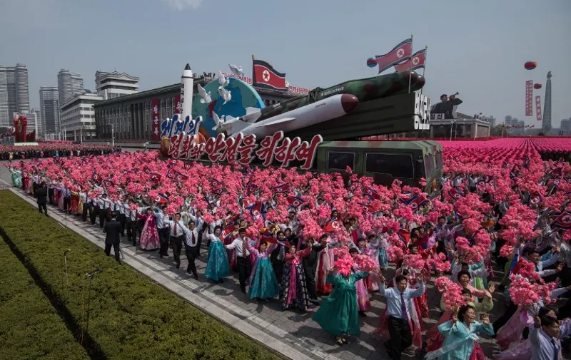 A rocket-themed float makes its way through Kim Il-Sung square during a mass rally marking the 105th anniversary of the birth of late North Korean leader Kim Il-Sung, in Pyongyang on April 15, 2017.  
Kim saluted as ranks of goose-stepping soldiers followed by tanks and other military hardware paraded in Pyongyang for a show of strength with tensions mounting over his nuclear ambitions. / AFP PHOTO / ED JONES