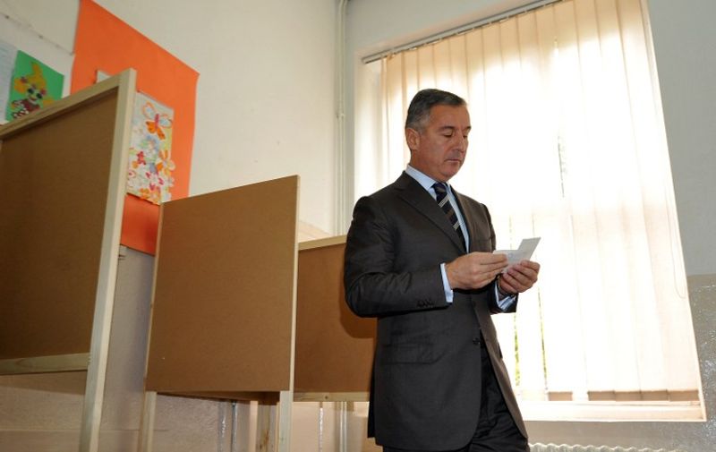 Milo Djukanovic, leader of the Democratic Party of Socialists (DPS), prepares to cast his ballot at a poling station in Podgorica on October 14, 2012. Montenegro voted today to choose a government that will lead European Union entry talks for the tiny Balkans country in the grip of a deep economic crisis. The ruling centre-left coalition led by the Democratic Party of Socialists (DPS), led by veteran politician Milo Djukanovic, called the elections six months before the official end of its mandate after the EU opened accession talks in June. AFP PHOTO / ANDREJ ISAKOVIC / AFP PHOTO / ANDREJ ISAKOVIC