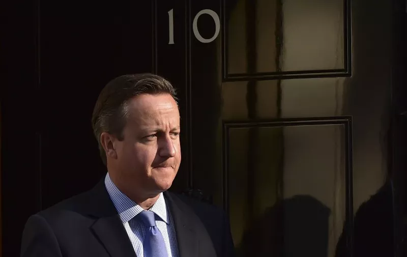 Britain's Prime Minister David Cameron waits to greet Israeli Prime Minister Benjamin Netanyahu (unseen) outside 10 Downing Street ahead of a meeting in London on September 10, 2015. British Prime Minister David Cameron held talks with Israeli Prime Minister Benjamin Netanyahu at his Downing Street residence in central London.  AFP PHOTO / LEON NEAL