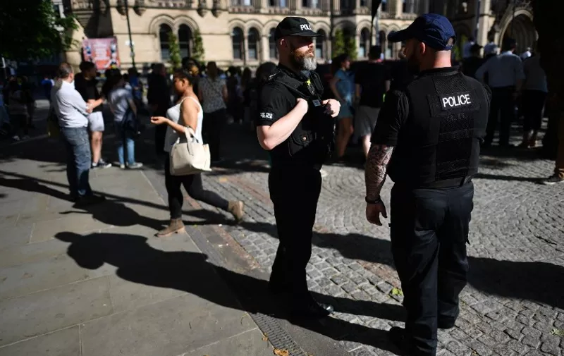 Police officers secure the area in Albert Square as the GreatCity Games gets underway in central Manchester, northwest England on May 26, 2017.
Thousands of people protected by armed policemen packed the streets of Manchester to watch the GreatCity Games just days after the suicide bomb at a pop concert in the city claimed 22 lives and wounded dozens. / AFP PHOTO / Ben STANSALL