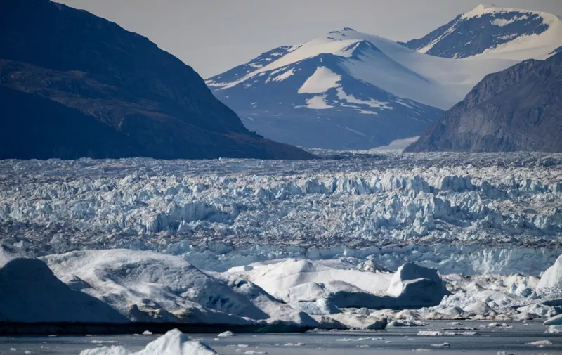 This photograph taken on August 15, 2023, shows icebergs released by one of the biggest glaciers of the area as it melts due to warm temperatures in the Scoresby Sound Fjord, in Eastern Greenland. The French National Centre for Scientific Research is undertaking an expedition to explore Greenland's isolated fjords, the planet's largest fjord system, which remains vastly understudied. The expedition, arranged by the volunteer-run French initiative Greenlandia, is dedicated to understanding the climate change's effects on Scoresby Fjord and its inhabitants. (Photo by Olivier MORIN / AFP)