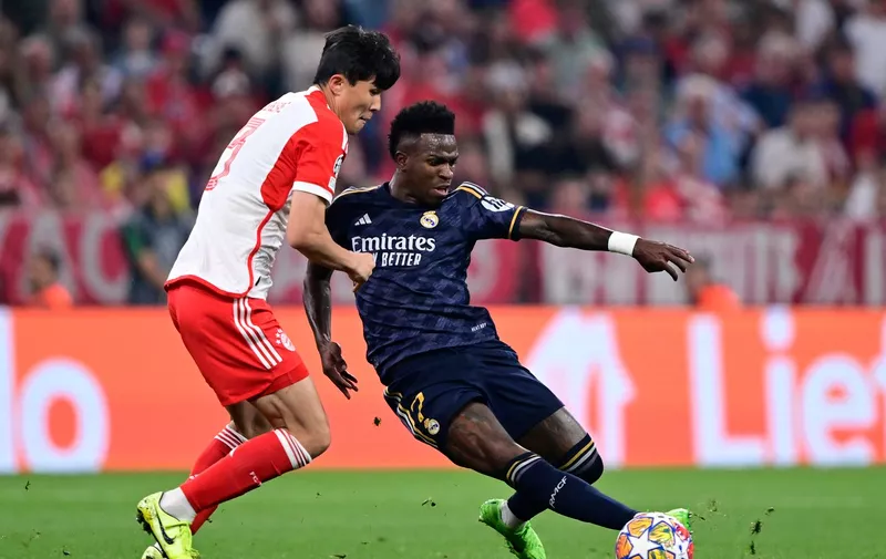 Bayern's Kim Min-jae, left, challenges for the ball with Real Madrid's Vinicius Junior during the Champions League semifinal first leg soccer match between Bayern Munich and Real Madrid at the Allianz Arena in Munich, Germany, Tuesday, April 30, 2024. (AP Photo/Christian Bruna)