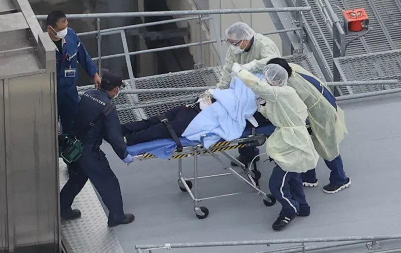 An aerial photo shows a man believed to be former Japanese Prime Minister Shinzo Abe on the stretcher at Nara Medical University Hospital  in Kashihara,  Nara Prefecture on July 8, 2022. Abe went on a stumping tour for supporting his party member in the House of Councillors Election.  67-year-old Abe has reportedly been shot in the chest and he has been in a state of cardio-respiratory arrest. ( The Yomiuri Shimbun ) (Photo by Shohei Izumi / Yomiuri / The Yomiuri Shimbun via AFP)