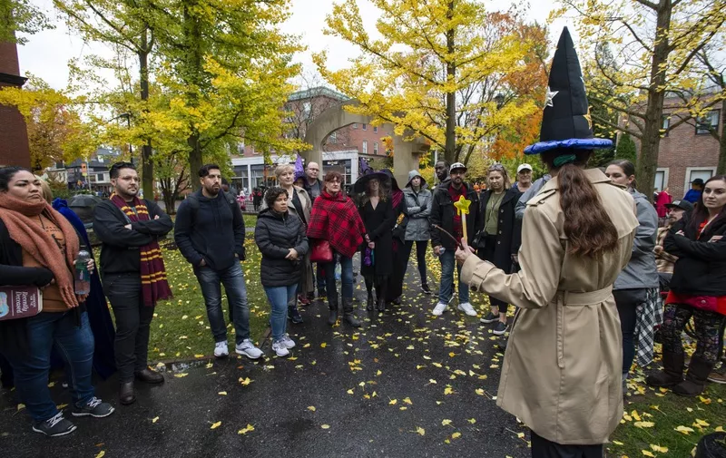 Tourist listen to a tour guide at a ghost tour during Halloween on October 31, 2019 in Salem, Massachusetts. Salem is a mecca for witches and fans of the occult, attracting thousands of visitors from around the world every year to celebrate the Halloween holiday. (Photo by Joseph Prezioso / AFP)